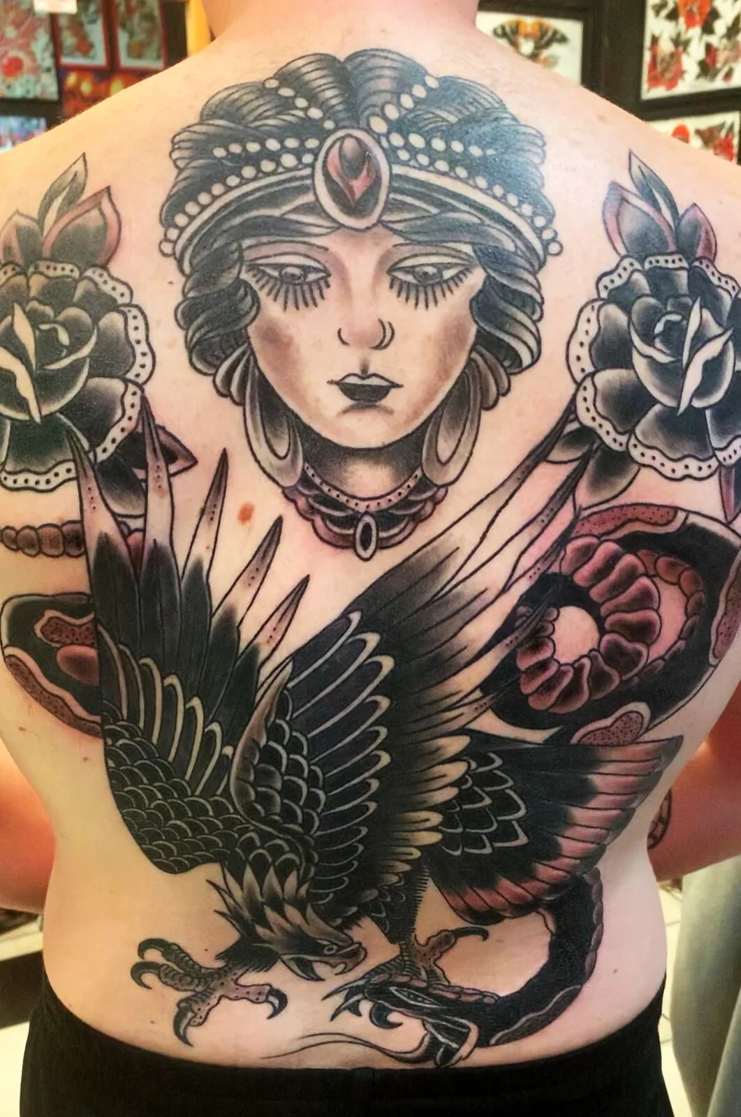 Black and grey traditional gypsy woman, eagle, snake and roses backpiece tattoo by Tim Goodrich, Waikiki, Hawaii