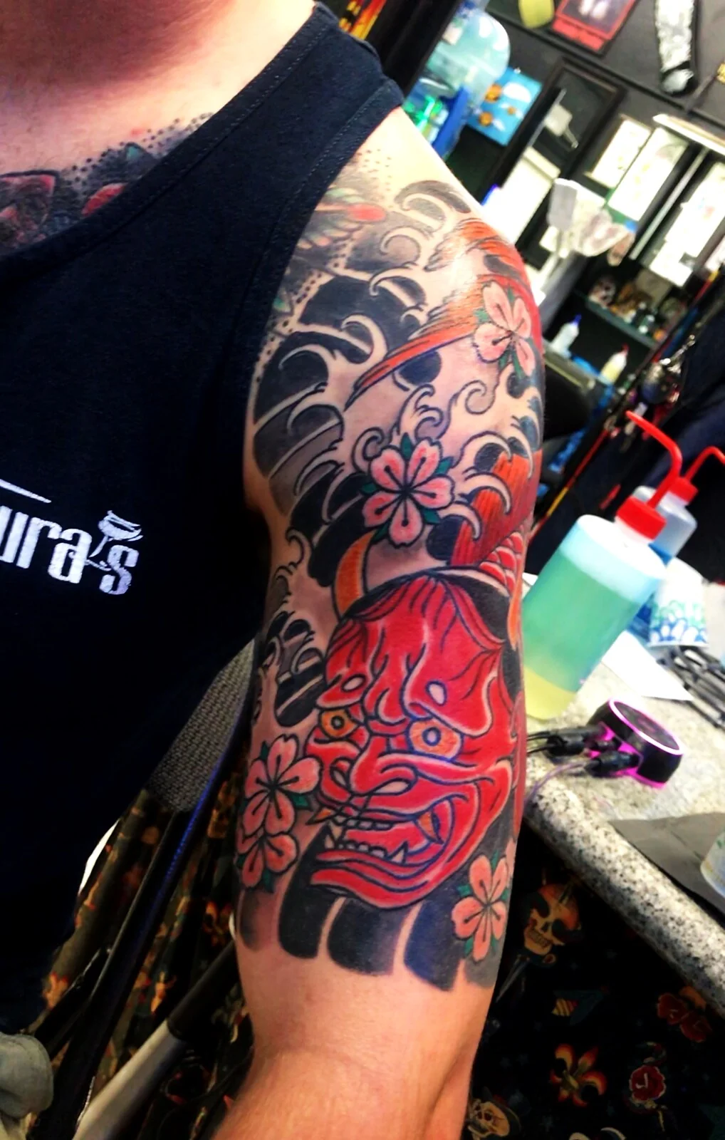 Japanese Wabori hannya mask with cherry blossoms half-sleeve tattoo by Tim Goodrich, Waikiki, Hawaii